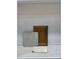 Close-up of a wood kitchen cabinet door, quartz countertop and backsplash samples at 13408 Chopin Ridge Rd, Huntersville, NC 28078