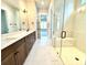 Bathroom showcasing double vanity and glass shower with marble-look tile throughout at 174 Fulworth Nw Dr # 65, Concord, NC 28027