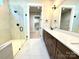 Modern bathroom featuring double vanity, glass enclosed shower, and marble-look tile floors at 174 Fulworth Nw Dr # 65, Concord, NC 28027