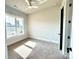 Cozy bedroom with ceiling fan and large window at 174 Fulworth Nw Dr # 65, Concord, NC 28027