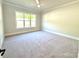 Bedroom featuring a large window with natural light and neutral carpet at 174 Fulworth Nw Dr # 65, Concord, NC 28027