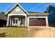 Charming home featuring stone accents, a covered porch, and a two-car garage at 174 Fulworth Nw Dr # 65, Concord, NC 28027