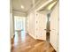 Bright hallway featuring hardwood floors, a doorway to the office, and a view of the entrance at 174 Fulworth Nw Dr # 65, Concord, NC 28027