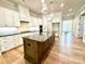 Beautiful kitchen with white cabinets, a center island, and black countertops at 174 Fulworth Nw Dr # 65, Concord, NC 28027