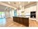 Open kitchen with white cabinets, a large island, hardwood floors, and modern appliances at 174 Fulworth Nw Dr # 65, Concord, NC 28027