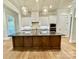 Modern kitchen featuring a large island, pendant lighting, and white cabinetry at 174 Fulworth Nw Dr # 65, Concord, NC 28027