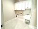 Functional laundry room featuring storage cabinets and a sink for added convenience at 174 Fulworth Nw Dr # 65, Concord, NC 28027