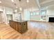 Open-concept layout with a dark kitchen island and fireplace for a modern feel at 174 Fulworth Nw Dr # 65, Concord, NC 28027