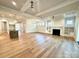 Spacious living area with hardwood floors, fireplace and seamlessly connects to the kitchen at 174 Fulworth Nw Dr # 65, Concord, NC 28027