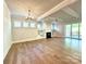 Bright living room featuring hardwood floors, a fireplace, and seamless flow to the backyard at 174 Fulworth Nw Dr # 65, Concord, NC 28027