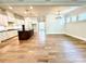 Spacious open-concept living room with hardwood floors flowing into the modern kitchen at 174 Fulworth Nw Dr # 65, Concord, NC 28027