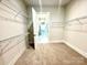 Walk-in closet featuring wire shelving and carpeted floor at 174 Fulworth Nw Dr # 65, Concord, NC 28027