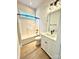 This bathroom features tile floors, vanity lighting, and bright white tub with shower at 178 Fulworth Nw Dr # 64, Concord, NC 28027