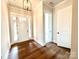 Bright home entryway featuring hardwood floors and a glass paneled front door at 178 Fulworth Nw Dr # 64, Concord, NC 28027