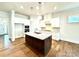 Modern kitchen with white cabinets, granite countertops, stainless appliances, and dark island at 178 Fulworth Nw Dr # 64, Concord, NC 28027