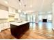 Open-concept kitchen with stainless appliances, granite countertops, and hardwood floors at 178 Fulworth Nw Dr # 64, Concord, NC 28027