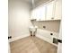 This laundry room features cabinets, a sink, tile floors, and neutral walls at 178 Fulworth Nw Dr # 64, Concord, NC 28027