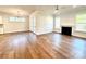 Living room featuring hardwood floors, a fireplace, contemporary light fixtures, and access to the patio at 178 Fulworth Nw Dr # 64, Concord, NC 28027