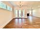Spacious living room with French doors and elegant chandelier at 178 Fulworth Nw Dr # 64, Concord, NC 28027