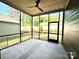 This is a view of the screened-in porch and backyard beyond at 178 Fulworth Nw Dr # 64, Concord, NC 28027