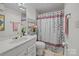 Clean bathroom with a vanity, decorative shower curtain, and modern fixtures at 1832 J Julian Ln # D, Charlotte, NC 28208