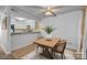 Cozy dining area features modern lighting and a wooden table adjacent to the kitchen at 1832 J Julian Ln # D, Charlotte, NC 28208