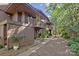 Multi-story home boasts a private balcony and landscaped walkway surrounded by mature trees at 1832 J Julian Ln # D, Charlotte, NC 28208