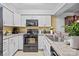 Well-lit kitchen boasts white cabinetry, granite countertops, and stainless steel appliances at 1832 J Julian Ln # D, Charlotte, NC 28208