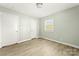 Empty bedroom showcasing wood flooring, neutral-colored walls, and natural lighting at 1905 Wood St, Gastonia, NC 28052