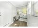 A laundry room with white walls and hardwood flooring featuring a window with natural light at 1905 Wood St, Gastonia, NC 28052