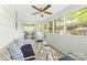 Relaxing sunroom featuring comfortable seating, ample natural light, and ceiling fan at 1905 Wood St, Gastonia, NC 28052