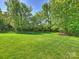 Spacious backyard with mature trees and a well maintained lawn at 2030 Gloucester St, Weddington, NC 28104