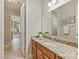 Well-lit bathroom with granite countertops, double sinks, and an open doorway to the main bedroom at 2030 Gloucester St, Weddington, NC 28104