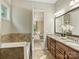 Bathroom features granite countertops, dual sinks, tile floors, and separate soaking tub at 2030 Gloucester St, Weddington, NC 28104