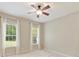 Bedroom features a ceiling fan, neutral carpet, and two windows allowing ample natural light at 2030 Gloucester St, Weddington, NC 28104