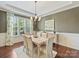 Elegant dining room with hardwood floors, stylish chandelier, large windows, and light colored walls at 2030 Gloucester St, Weddington, NC 28104