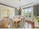 Charming dining room with hardwood floors, natural light, wainscoting, and a modern chandelier at 2030 Gloucester St, Weddington, NC 28104