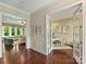 Spacious foyer showcasing hardwood floors, paneled walls, and an open view to the living room and office at 2030 Gloucester St, Weddington, NC 28104