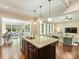 Open concept kitchen with island and view to the living and dining areas at 2030 Gloucester St, Weddington, NC 28104