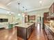 Modern kitchen with stainless appliances and center island overlooking the living room at 2030 Gloucester St, Weddington, NC 28104