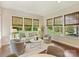 Bright living room with hardwood floors, neutral decor, comfortable seating, and many windows at 2030 Gloucester St, Weddington, NC 28104