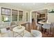Living room open to kitchen area features hardwood floors, neutral decor, comfortable seating, and many windows at 2030 Gloucester St, Weddington, NC 28104