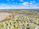 This aerial view shows a wide angle of the neighborhood, highlighting the houses and the nearby woods at 2146 Holden Sw Ave, Concord, NC 28025