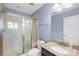Bright bathroom features a glass shower, granite countertop, and blue walls at 2146 Holden Sw Ave, Concord, NC 28025