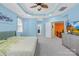 Large bedroom featuring tray ceilings, gray carpet, and a ceiling fan at 2146 Holden Sw Ave, Concord, NC 28025