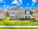 Beautiful two-story home featuring well-maintained landscaping, a stone facade, and a welcoming entrance at 2146 Holden Sw Ave, Concord, NC 28025