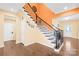 Inviting foyer featuring hardwood floors and a staircase with wrought iron spindles and a turned, wood banister at 2146 Holden Sw Ave, Concord, NC 28025