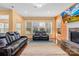 Sun-filled living room featuring a fireplace, large windows, and comfortable seating for relaxation and entertainment at 2146 Holden Sw Ave, Concord, NC 28025