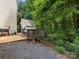 Outdoor area featuring deck and gravel area with lush foliage and trees and detached shed at 2214 Olde Chantilly Ct, Charlotte, NC 28205