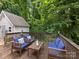 Inviting wooden deck with outdoor furniture, nestled among lush trees offering a serene retreat at 2214 Olde Chantilly Ct, Charlotte, NC 28205